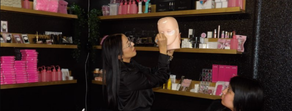 a woman holding a mannequin